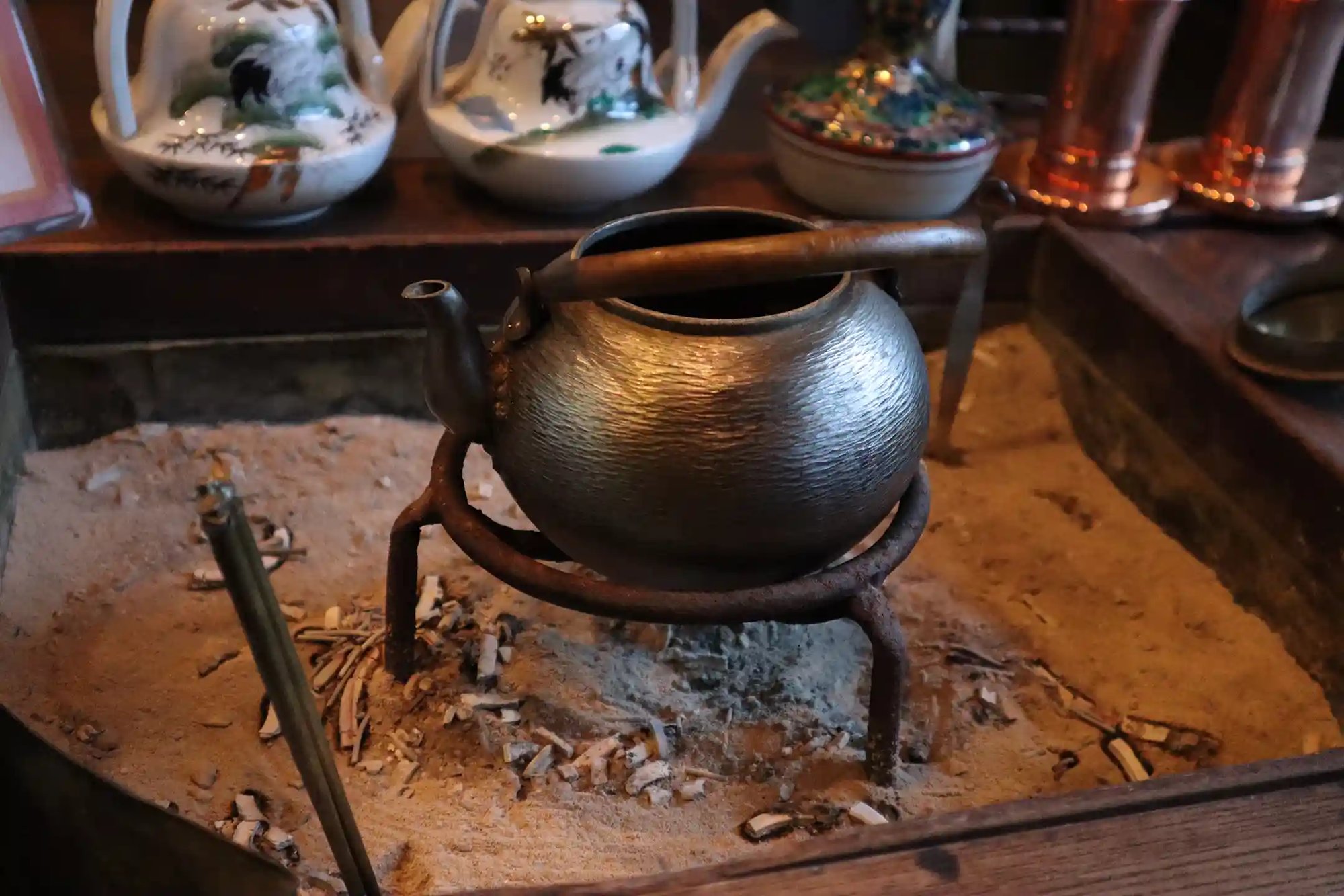 An iron kettle over a hearth