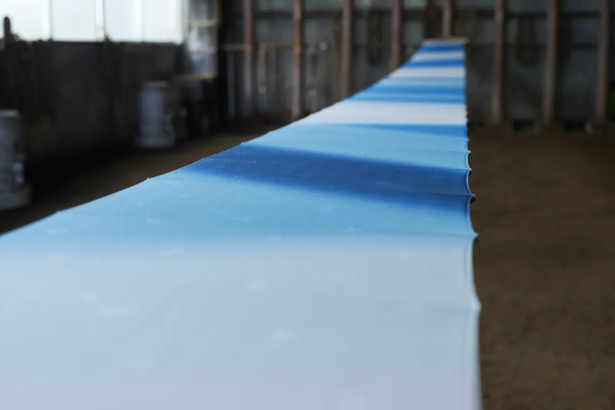 A long bolt of silk graded from white into blue