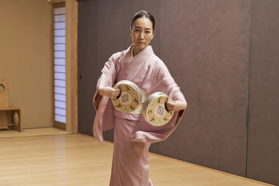 Yukari Onoe holding a blue and gold fan