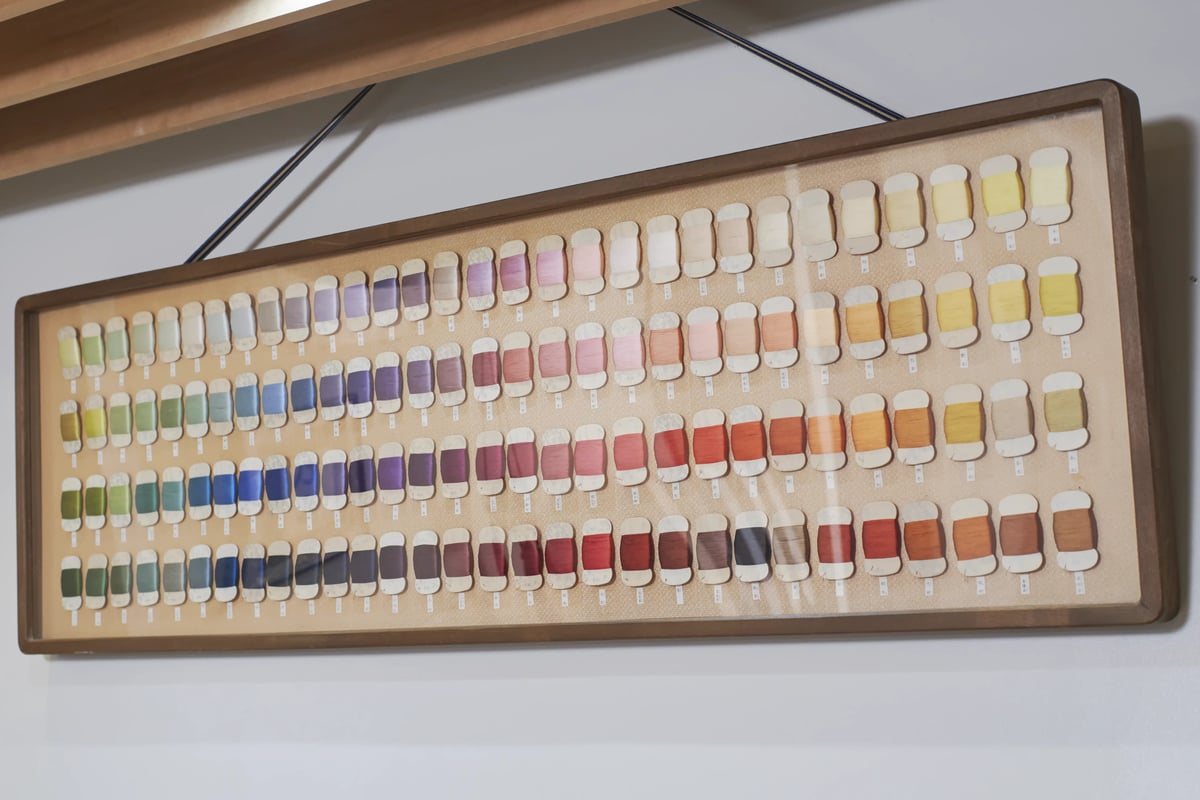 A framed chart of dyed silk colours