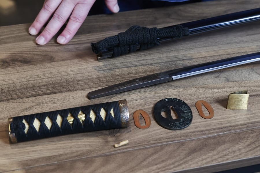 Sword fittings laid out on the bench