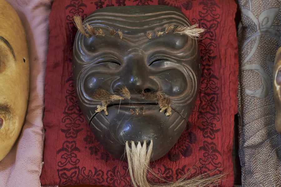 A kyōgen mask resting on cloth