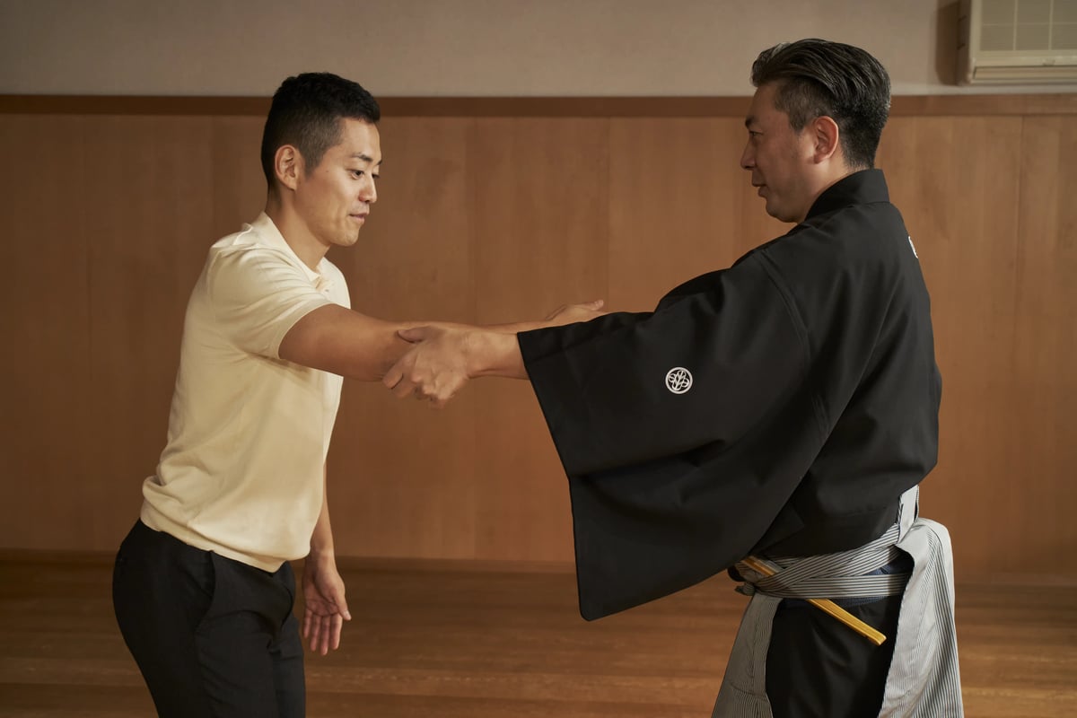 Ohkura guiding a visitor through a movement