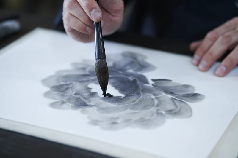 A brush laying ink on paper