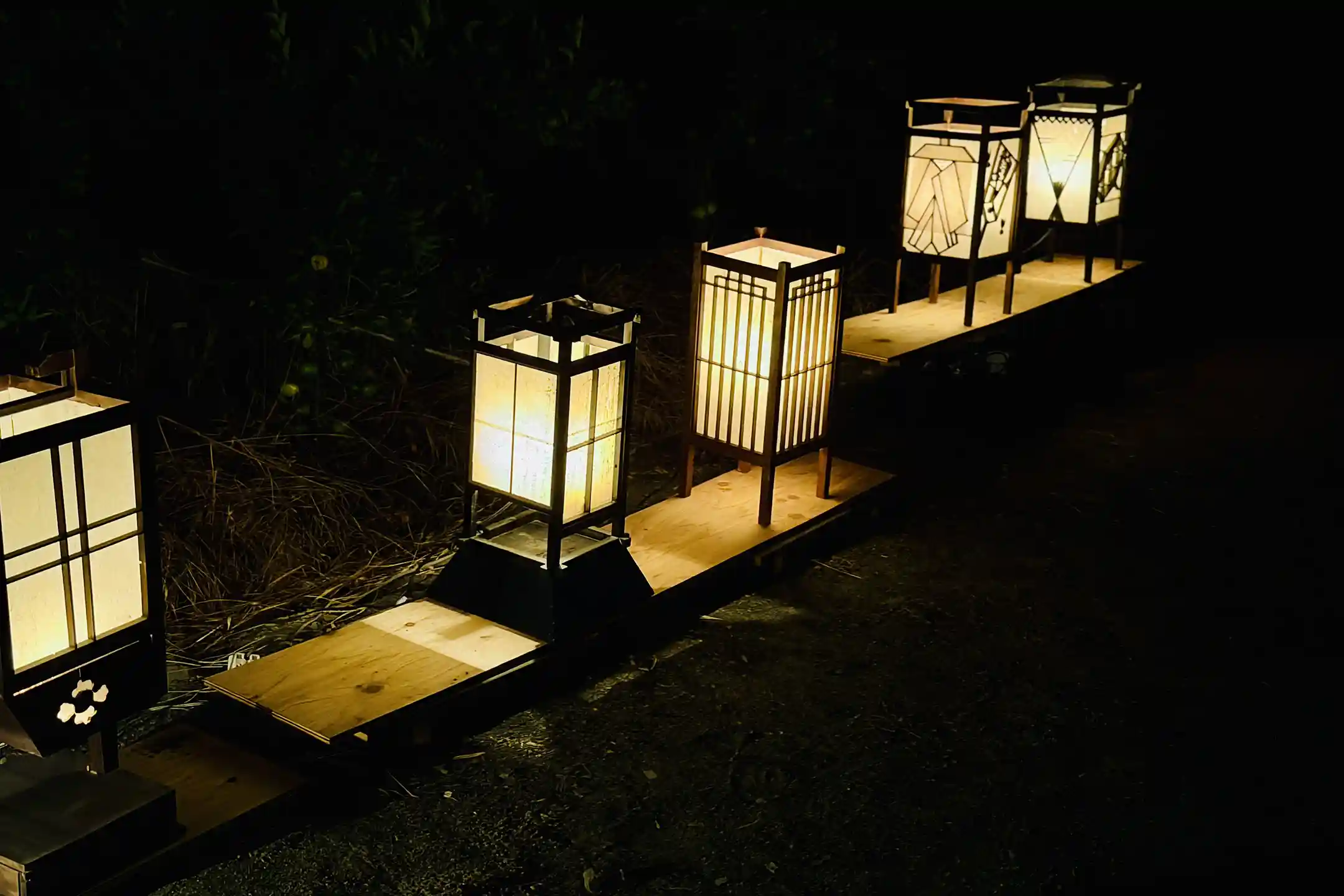 Lanterns lighting a path at night