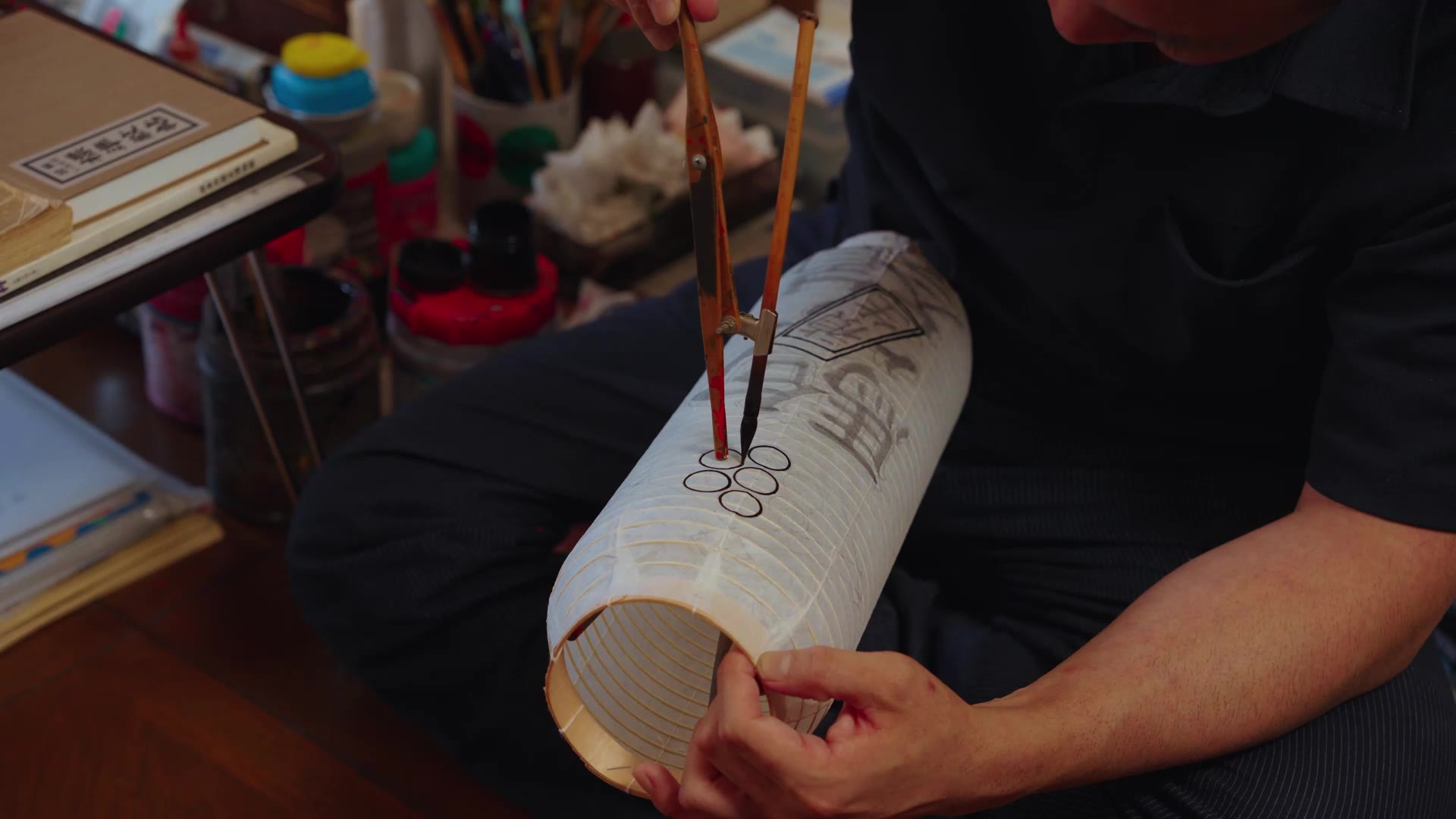 A design being painted onto a paper lantern