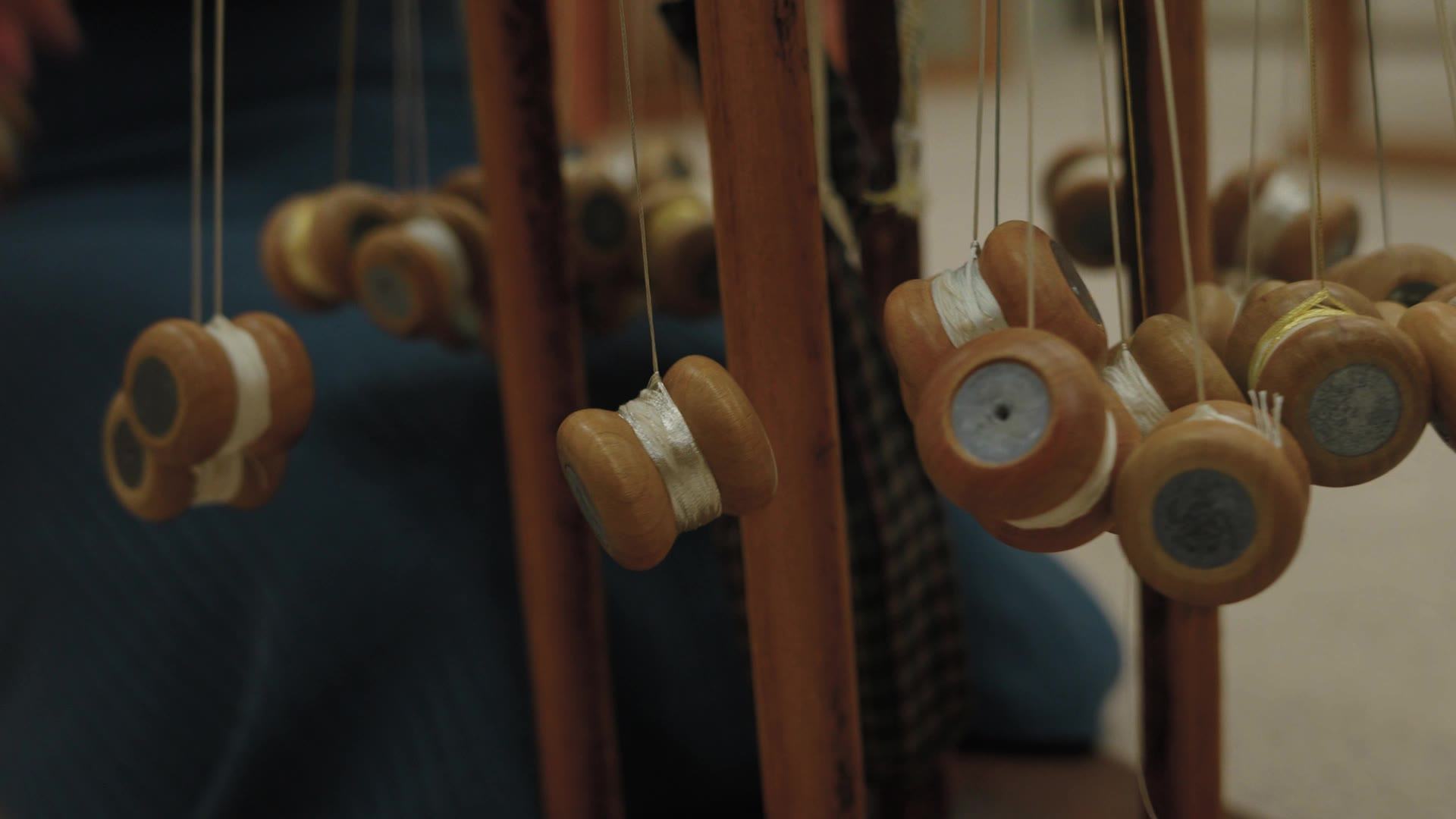 Silk thread wound on bobbins at a braiding stand