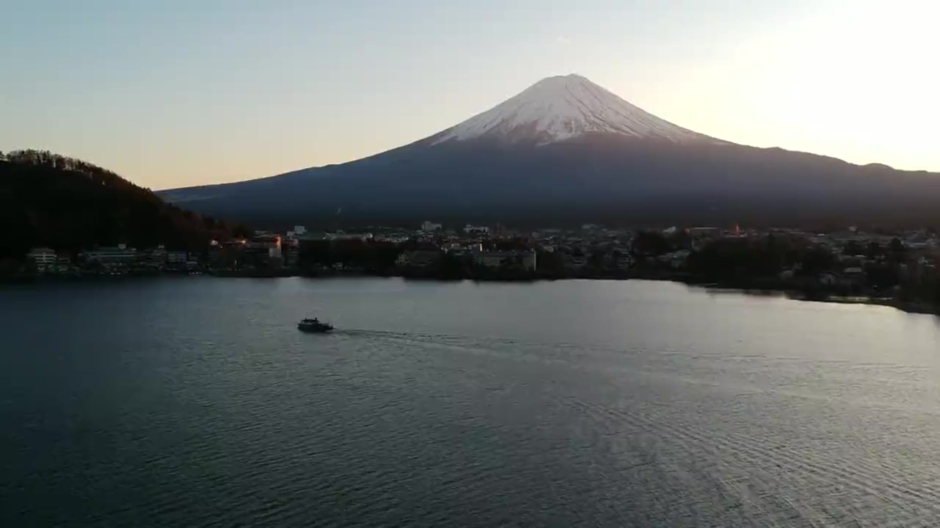 A volcanic peak at dusk above a still lake